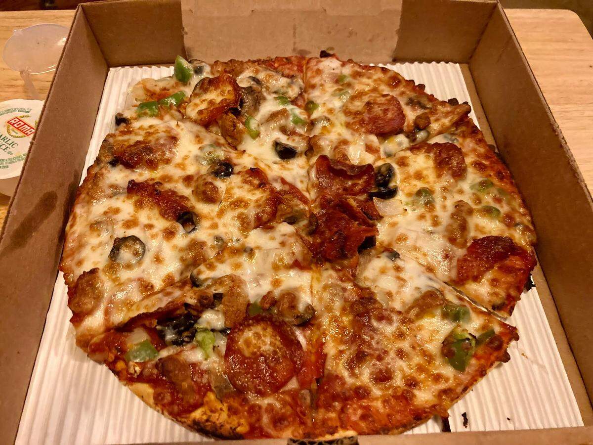 A “CowPie Deluxe” small pizza with pepperoni, Italian sausage, mushroom, green peppers, onions, black olives from CowPies Pizza Co.