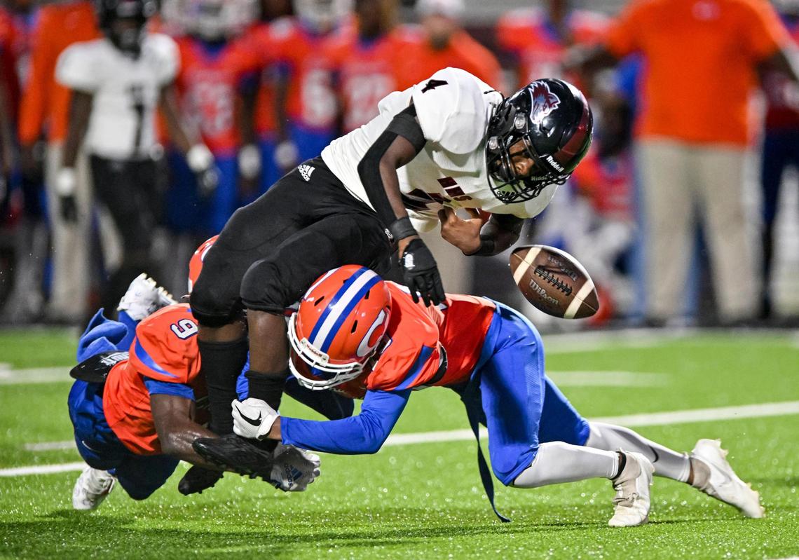 DONN RODENROTH,Macon, Georgia, 08/26/2022: Howard Husky Tybien Smith fumbles the ball as he is tackled by Central defenders (9) Jalen Darden and (19) Jalen Darden.