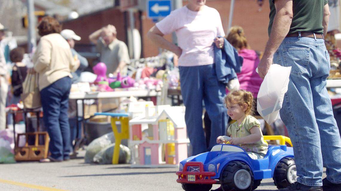 Tommy McCarter of Perry bought his granddaughter, Natalie, 2, wheels at the Peaches to the Beaches Yard Sale in this March 2007 Telegraph fie photo.