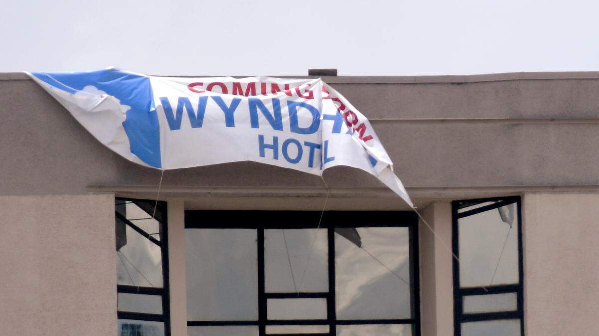 On Monday, a "coming soon" Wyndham banner hung atop the former downtown Ramada Plaza hotel in Macon.  It is slated to reopen in early 2019.