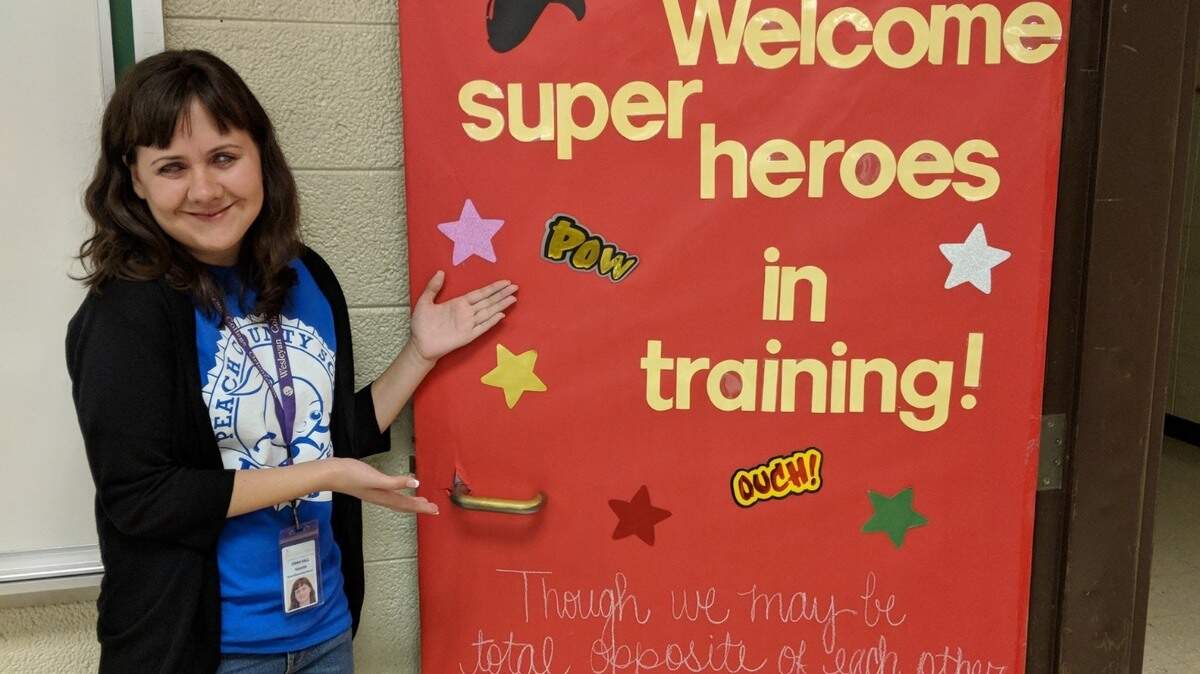 Ciara Hall shows off her classroom door at the beginning of her teaching career. Hall, who is blind, graduated from Wesleyan College and teaches at Byron Elementary
