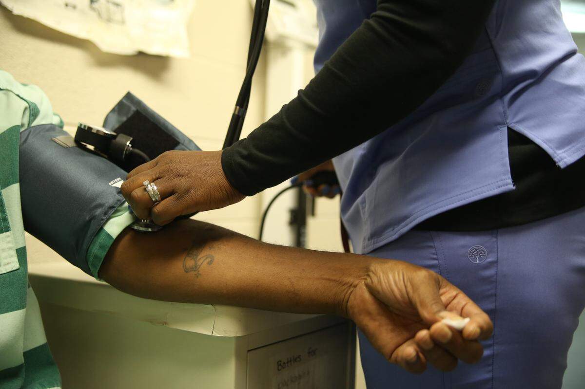 A CorrectHealth nurse monitors the blood pressure of a Monroe County inmate.