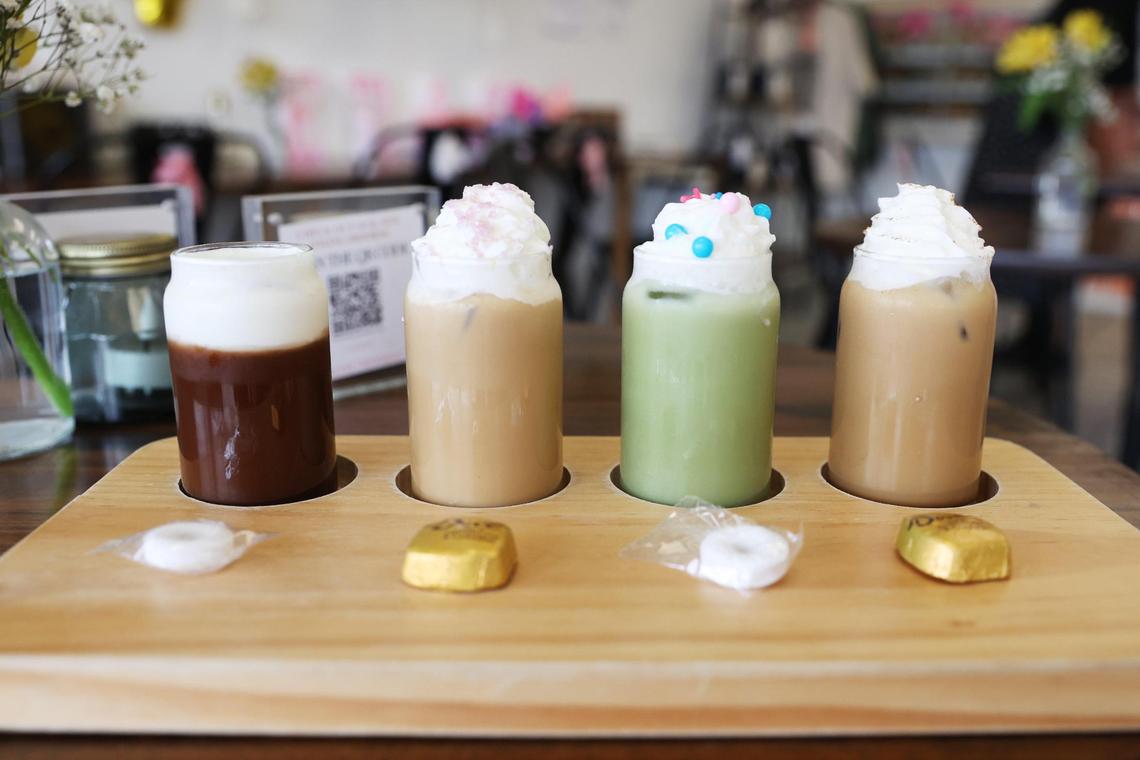 From left to right: The Lucky Ones, Enchanting to Meet You, LOML (Love of my Life Matcha) and Only the Young, all beverages with names inspired by Taylor Swift songs, sit in a coffee flight from Little Light Coffee Co.