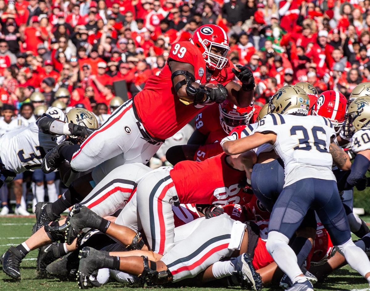 Georgia senior defensive lineman Jordan Davis (99) dives over the pile for a touchdown against Charleston Southern in first quarter action Saturday in Athens.