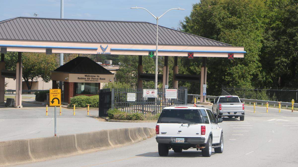 Vehicles enter the Russell Parkway gate at Robins Air Force Base on Sunday, two days after three men died in a crash with a security barrier at the gate. According to the base, the barrier was activated when the driver ignored orders to stop and sped through the gate.