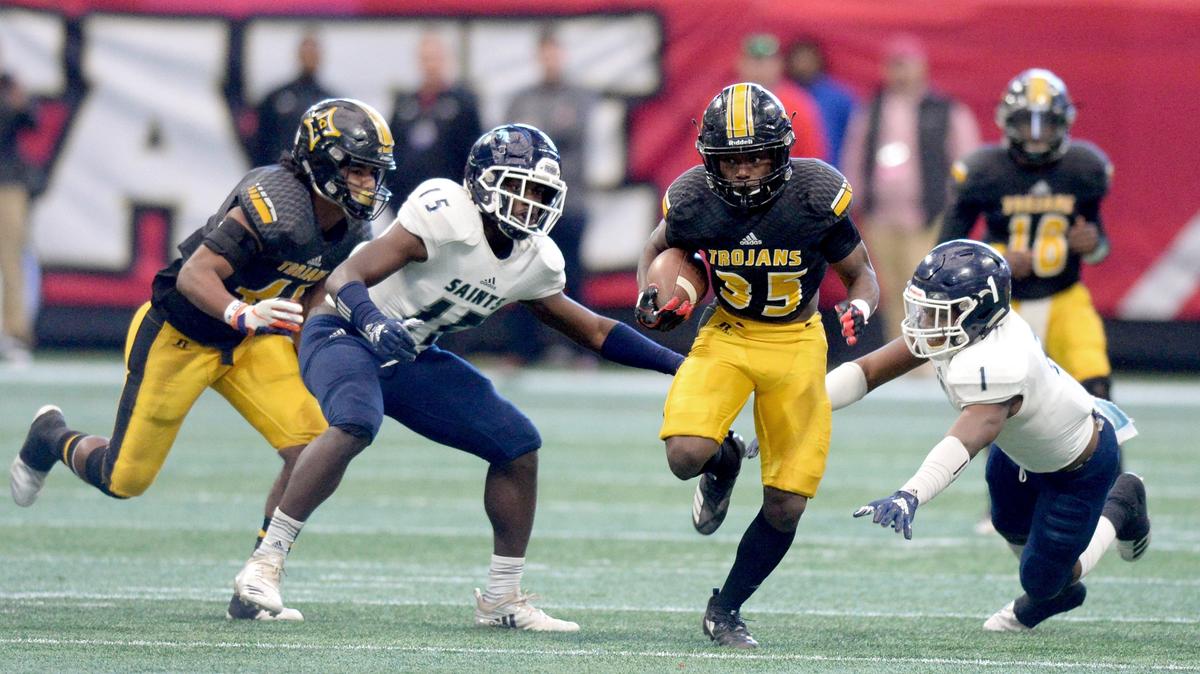 Peach County running back Noah Whittington (35) rushes for a first down during the Trojans’ GHSA State Championship game against Cedar Grove last season. The two teams meet in a rematch on Friday night..