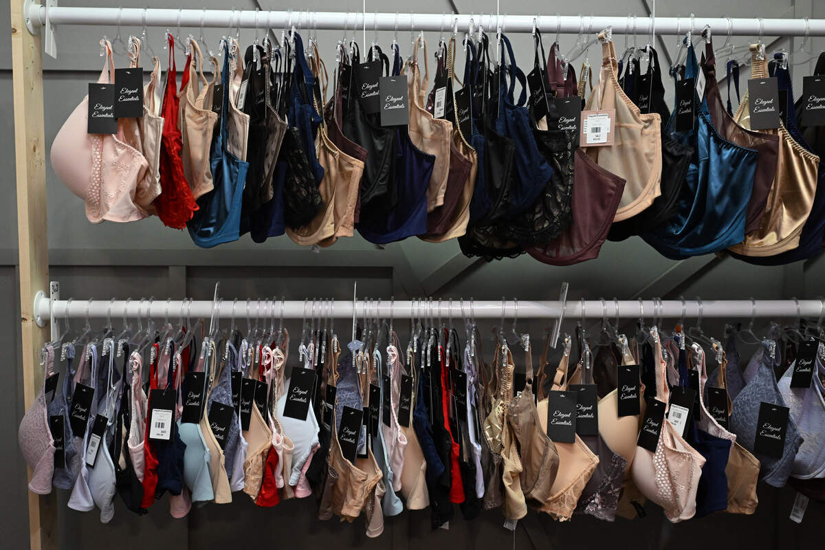 Owner Beth Strickland organizes inventory by size in the stockroom of Elegant Essentials in Warner Robins, Ga. Strickland’s bra salon carries band sizes 30-46 and cup sizes A-KK.