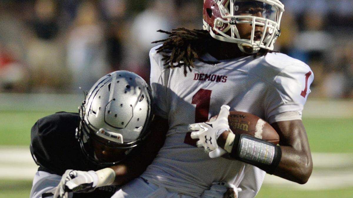 BEAU CABELL/THE TELEGRAPH 
 Warner Robins, Ga., 09/18/2015: Warner Robins wide receiver Marquez Callaway is caught from behind after catching a pass from Ivan Corbin.
