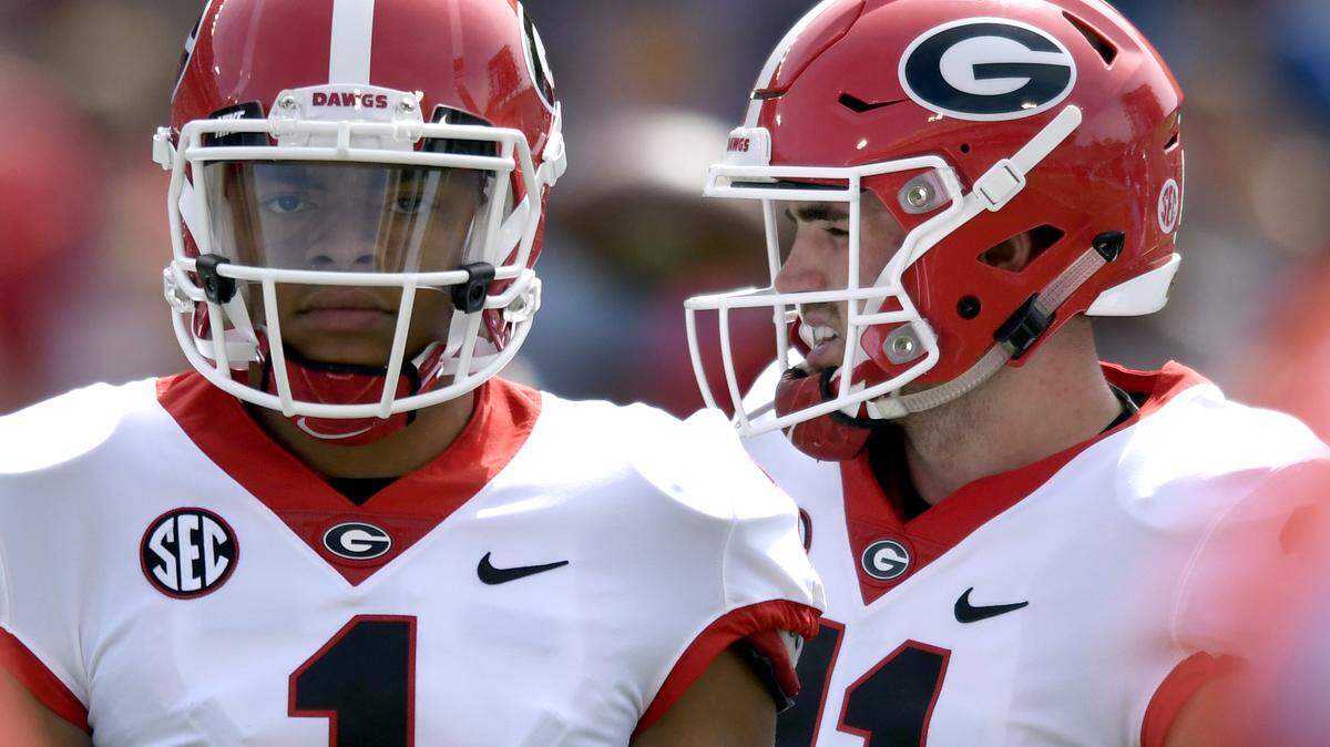 Georgia quarterbacks Jake Fromm (11) and Justin Fields (1) warm up prior to the Bulldogs' spring game in April.