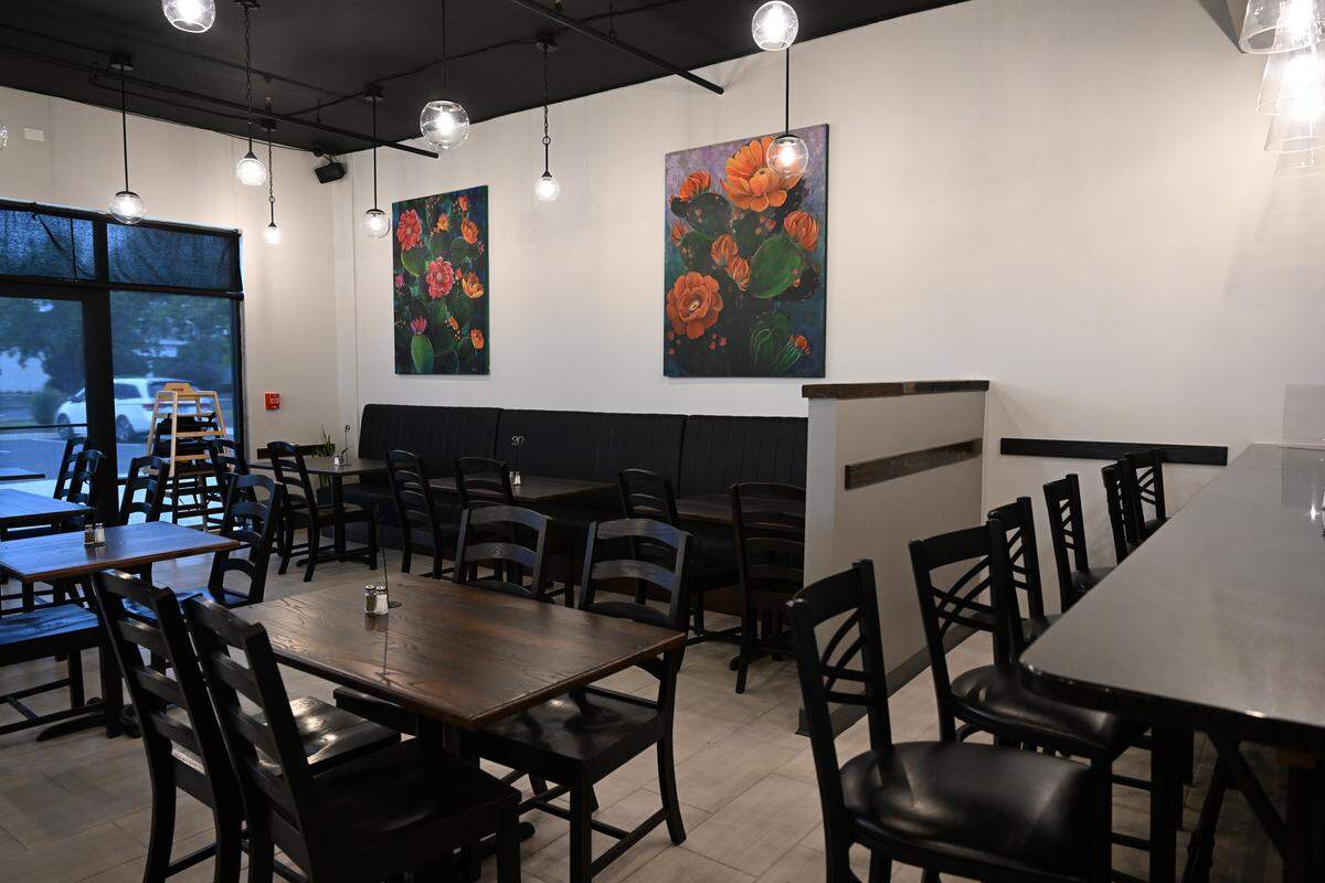 Cacti paintings hang inside of Fuego Fresco Mexican Restaurant on Thursday, Aug. 28, 2025, in Perry, Georgia. Julissa Decker, the daughter of Fuego Fresco co-owner Norma Thomas, painted all the paintings and the large mirror inside the restaurant.