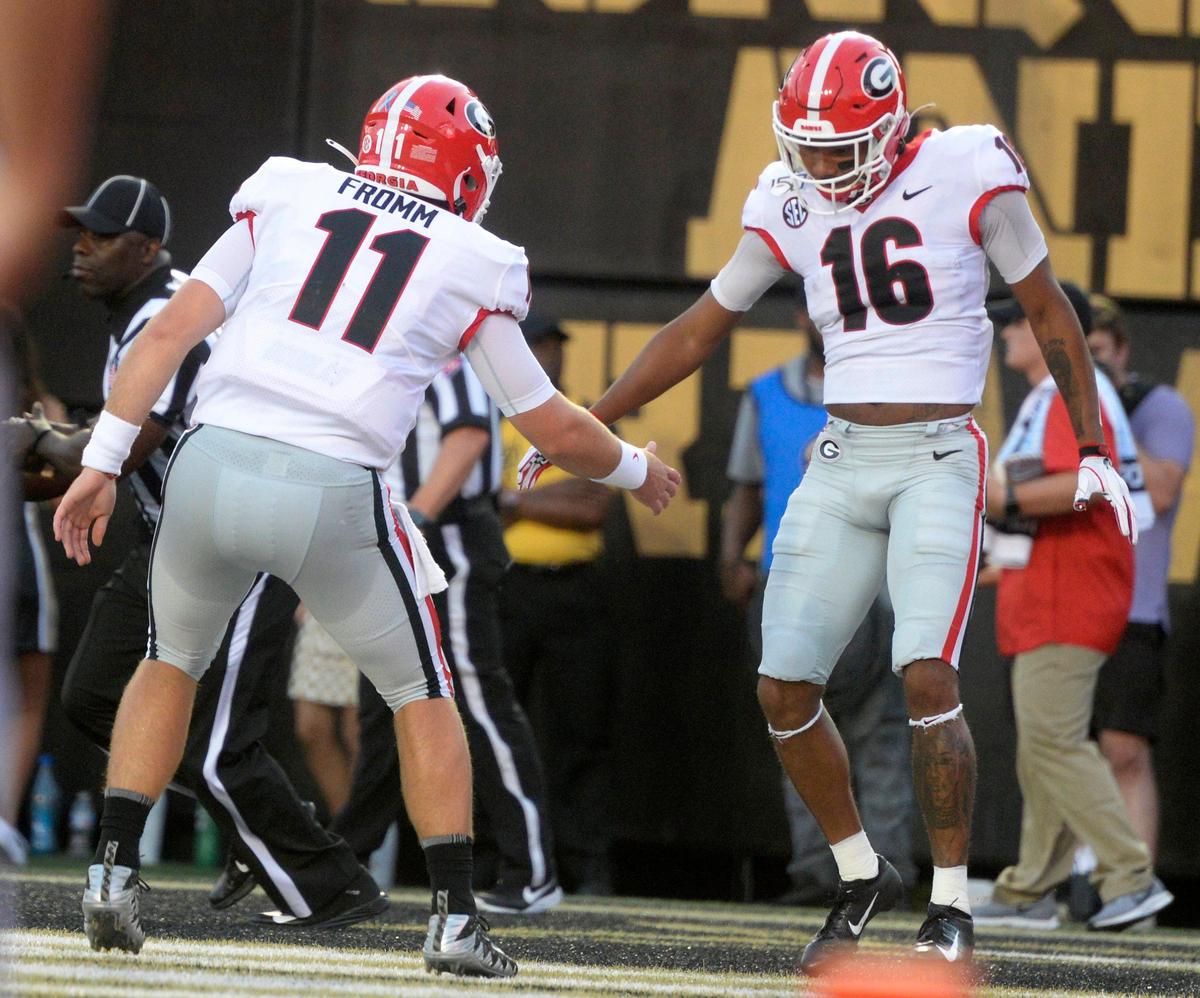 Georgia receiver Demetris Robertson (16) is congratulated by quarterback Jake Fromm (11) after a touchdown during the Bulldogs’ game against Vanderbilt Saturday night.
