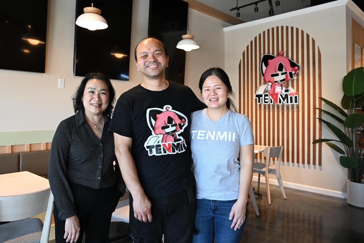 Tenmii Japanese Eatery owner and operator Kusmayadi “Han” Djunaidi (middle) poses in his new restaurant location with his wife Vita Tjhin (right) and business partner Thresia Wiguna on Tuesday, May 6, 2025, in Warner Robins. 