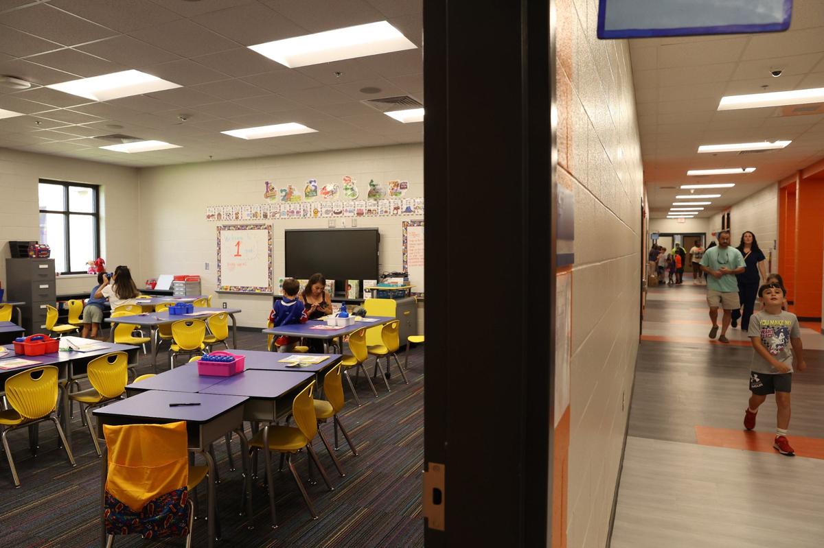 Students and families sit inside of Abigail Baker’s first grade classroom while others walk down the hallway in the newly renovated Springdale Elementary School on Friday, Aug. 2, 2024, in Macon, Georgia. The original Springdale Elementary opened 53 years ago, but this brand new building completed this summer will be ready for the new school year starting Aug. 5.