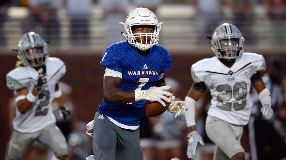 Veterans receiver Cordelle Clark (7) tucks away a long pass from quarterback Sebastian Verger as he outruns Houston County’s Damian Patterson (2) and Josh Whitehead (29) for the game’s first touchdown Friday at Freedom Field.