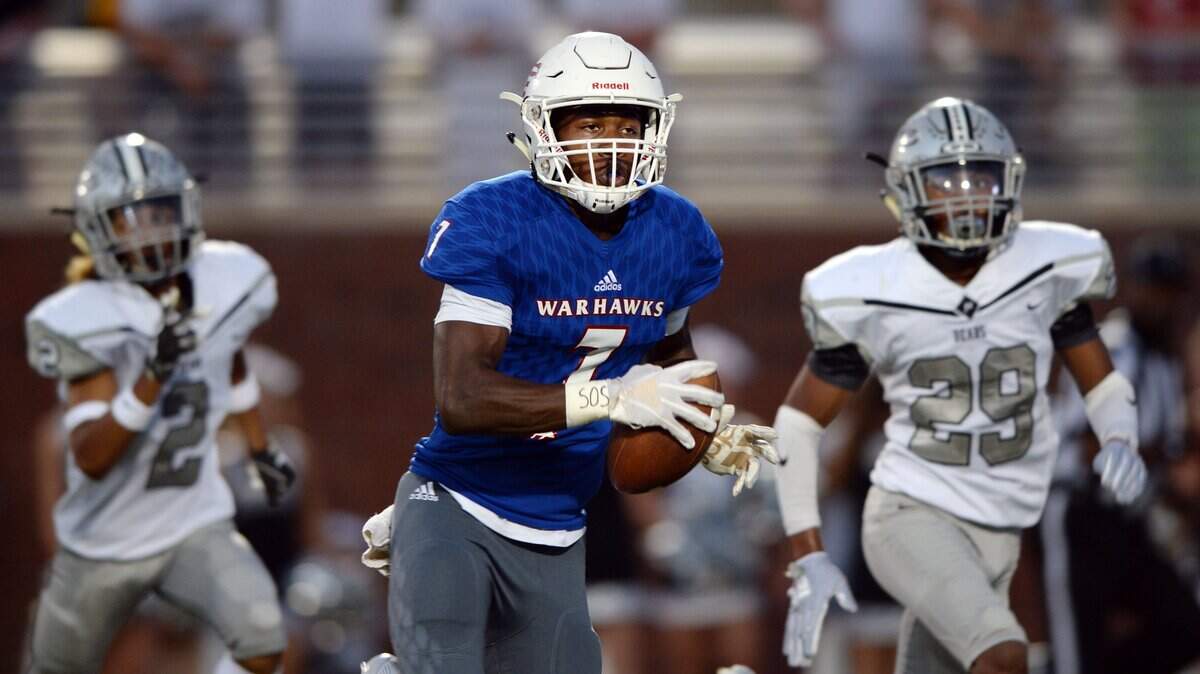 Veterans receiver Cordelle Clark (7) tucks away a long pass from quarterback Sebastian Verger as he outruns Houston County’s Damian Patterson (2) and Josh Whitehead (29) for the game’s first touchdown Friday at Freedom Field.