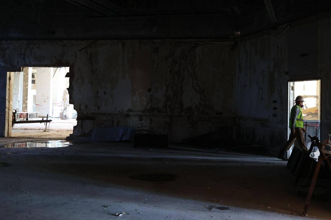 A construction worker walks through what was once the ballroom of the abandoned Ramada Hotel on Thursday, Dec. 12, 2024, in downtown Macon. Construction crews are preparing the 16-story hotel for a controlled implosion on New Year’s Day at 9 a.m.