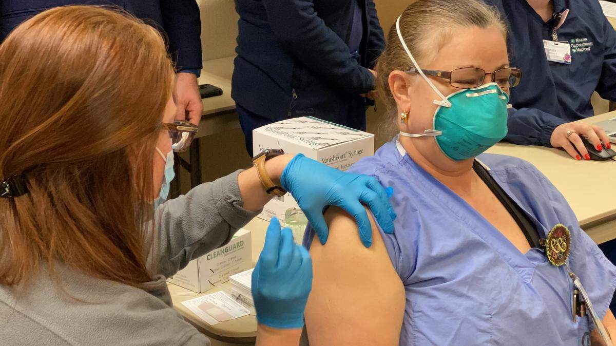 Charlene Crowe, RN and COVID care nurse at The Medical Center, Navicent Health receives the COVID-19 vaccine Monday Dec. 21, 2020.