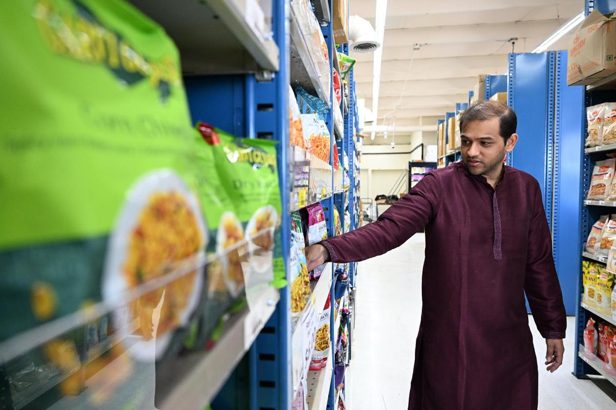 Malay Patel, a member of the five families that co-own the new Maharaja Market, points out one of his favorite Indian snacks on Wednesday, April 16, 2025, during its grand opening in Warner Robins. The Raju Nadiyadi Mix includes fried lentils, gram flour and spices.