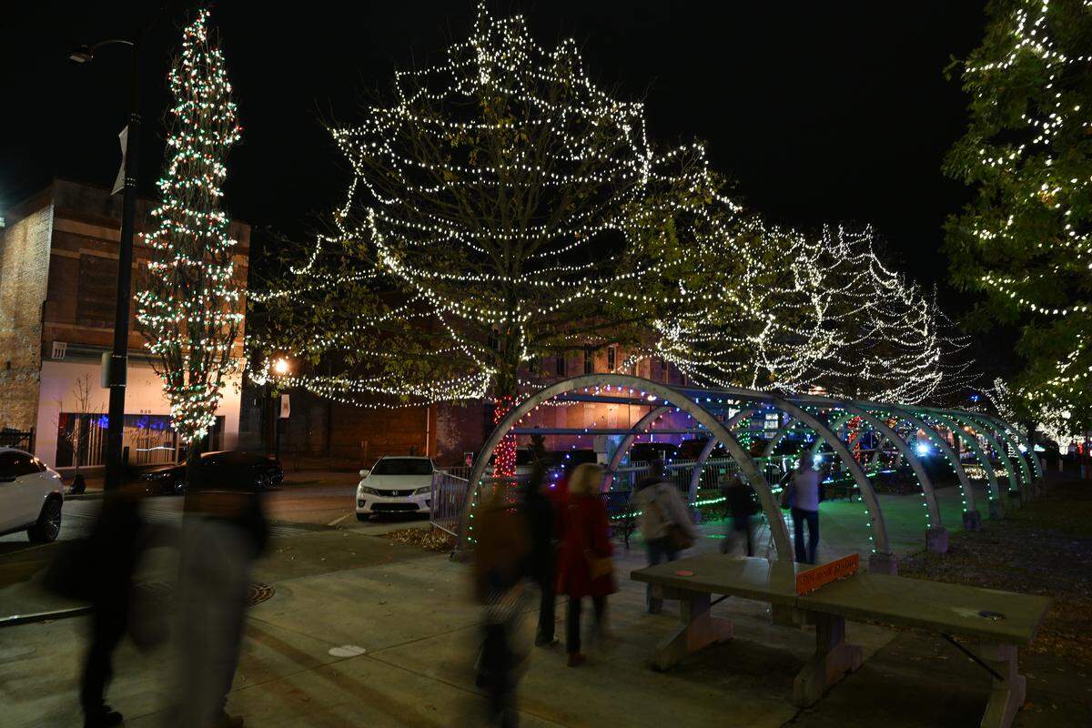 Visitors walk through the tunnel at the Macon Christmas Lights Extravaganza on Tuesday, Dec. 2, 2025, in downtown Macon, Georgia. The nightly light shows will occur throughout December.