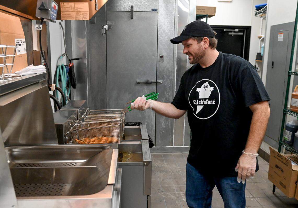 Franchise owner Wes Kostovetsky shakes a basket of chicken tenders at Chick’nCone that opens Saturday at 860 Forsyth St. in Macon.