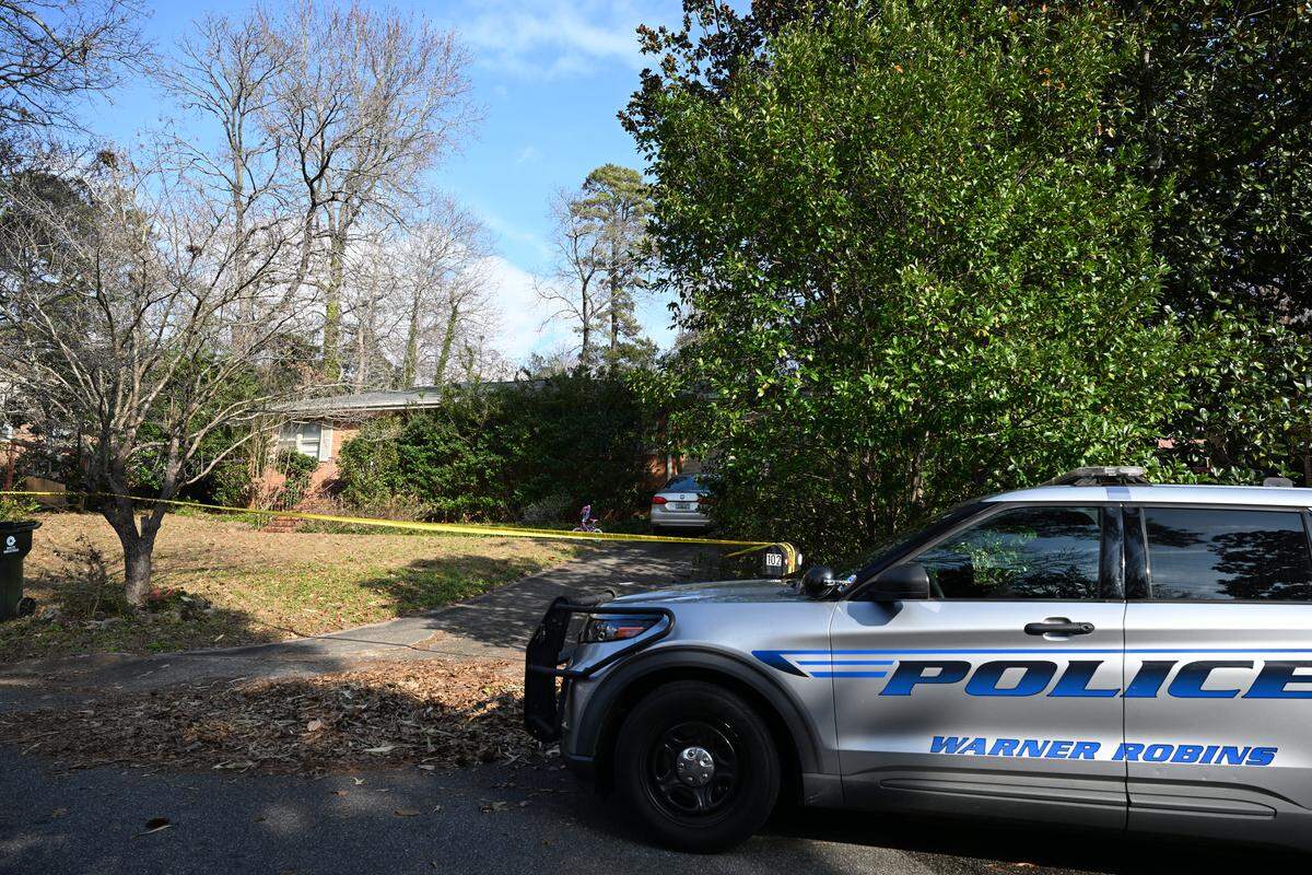A Warner Robins Police Department vehicle sits outside of a house on Kay Drive on Tuesday, Jan. 7, 2026, in Warner Robins, Georgia. Police found a woman dead and a man unresponsive in the house on Wednesday morning.
