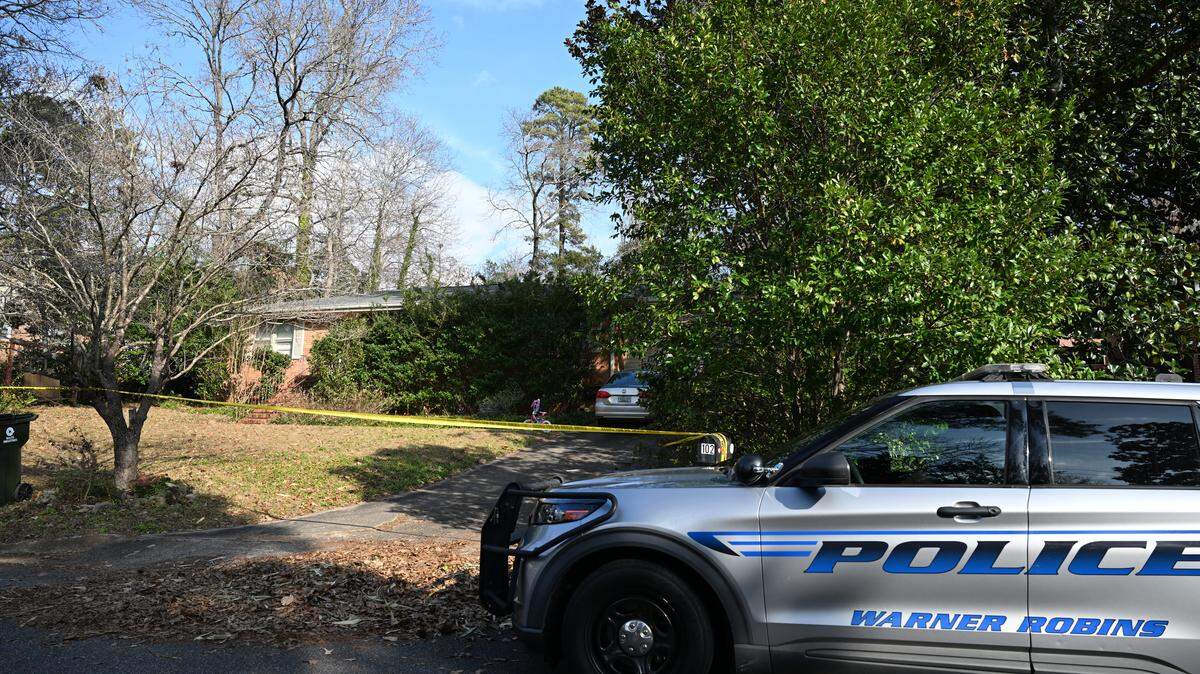 A Warner Robins Police Department vehicle sits outside of a house on Tuesday, Jan. 7, 2026, on Kay Drive in Warner Robins, Georgia. Police found a woman dead and a man unresponsive Wednesday morning in the home.