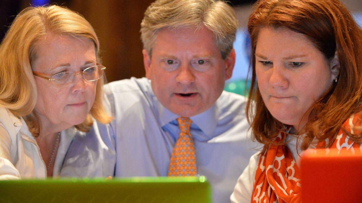 Daryl Morton, center, watches early returns come across in the 2014 school board election with wife, Amy, left, and Lauren Benedict at the Cox Capitol Theater. Morton is seeking re-election in the May 2018 election.