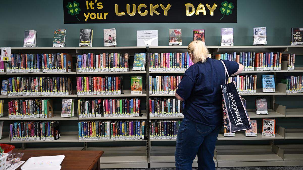 A library visitors looks through the Lucky Day books section in the new Cathy Ivey Community Library on Monday, Oct. 13, 2025, in Macon, Georgia. The newest Middle Georgia Regional Library location opened Monday and honors the life of longtime volunteer Cathy Ivey.