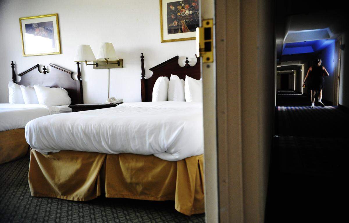 This photo from 2012 shows Pat Geiger, one of two on site caretakers living in the basement of the Ramada Plaza in Macon, walks down a hall darkened for lack of electricity while showing the hotel to a reporter recently. The hotel, now shuttered, has experienced financial since its opening in the 1960s as a Hilton.