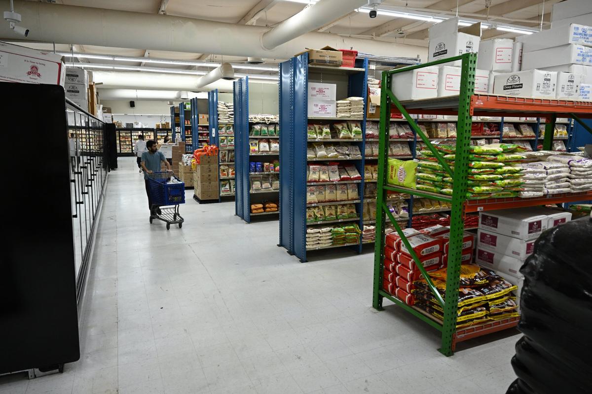 A customer walks past the aisles of Maharaja Market on Wednesday, April 16, 2025, during its grand opening in Warner Robins.