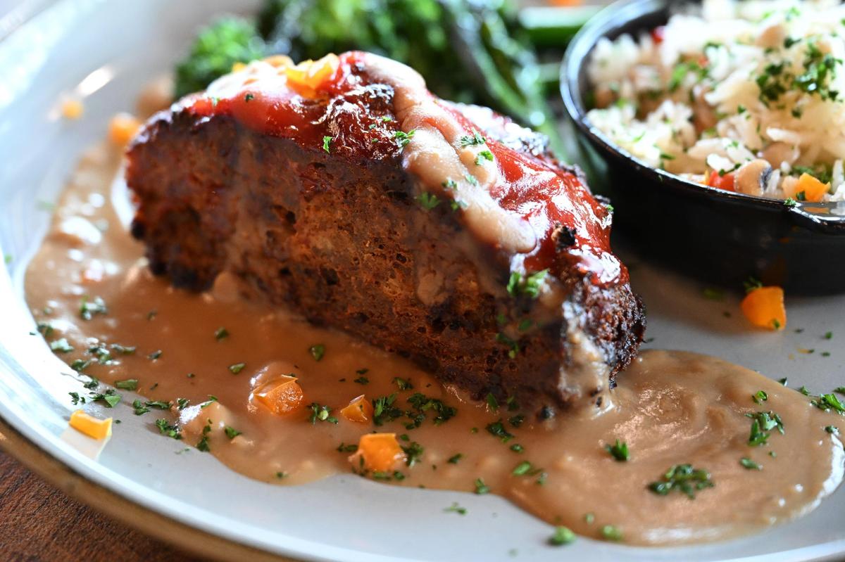 Sweet Mama’s Meatloaf from The Iron Rail sits on a plate with a side of Hoppin Johns and the vegetable of the day on Friday, April 25, 2025, in Bolingbroke, Georgia. The meatloaf is based on a Watson family recipe and has been one of the restaurant’s most popular items since opening.