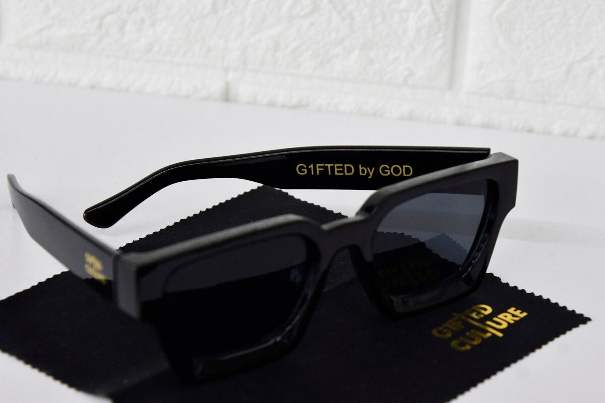 A pair of sunglasses from G1fted Culture sit on a shelf in Lace Era on Thursday, June 6, 2024, in Macon, Georgia. G1fted Culture is a faith-based apparel brand created in Macon that aims to inspire people to show off their God-given talents through fashion statements.