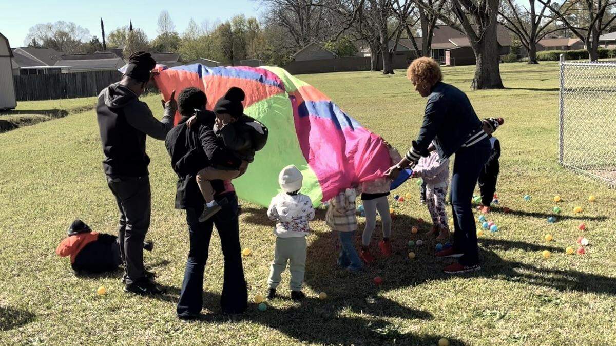 Parents and children play at a news conference on Tuesday regarding child care in Middle Georgia.