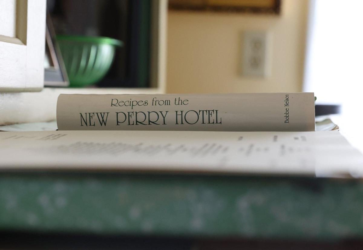 “Recipes from the New Perry Hotel” by Bobbie Nelson sits on a table in the New Perry Hotel exhibit of the Perry Area Historical Museum on Wednesday, Sept. 11, 2024, in Perry, Georgia. The book provides both a written history of the museum as well as recipes from the restaurant of the hotel.
