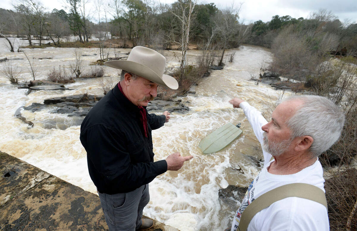 Guy Sidney Fried, left, and Jack Wilson stand atop the Ocmulgee River dam at Juliette on Feb. 12 where they compared notes on how best to recover Fried’s jet boat. Fried lost control of the boat as he was launching it. He was planning on boating up river but instead watched as the current took it downstream quickly and it went over the dam. “First time that’s ever happened,” said Fried, an avid sportsman.