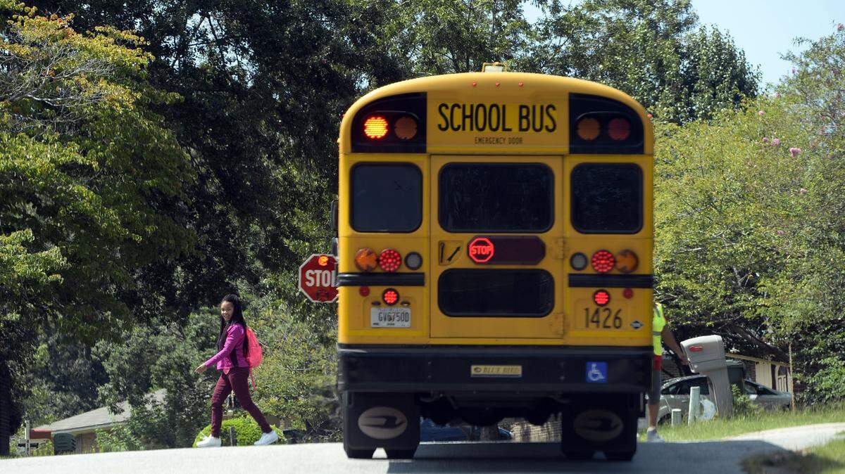 A Bibb County school bus drops a student off on Carlo Drive in west Macon in this 2017 file photo.