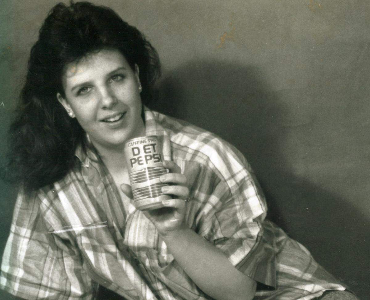 Sabrina Long playfully models a soft drink in an undated family photo.