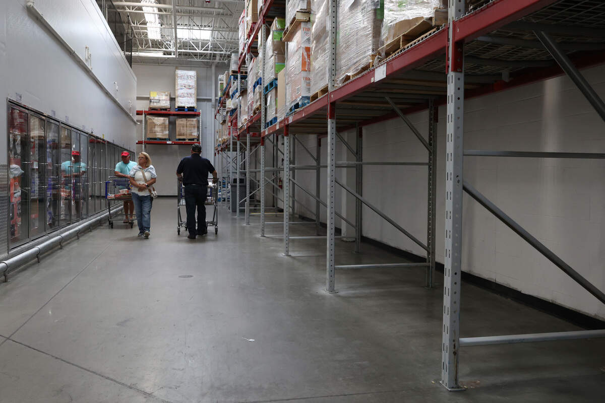 Sams Club shoppers walk past an empty area where plastic water bottles usually sit on Wednesday, Oct. 2, 2024, in Macon, Georgia.