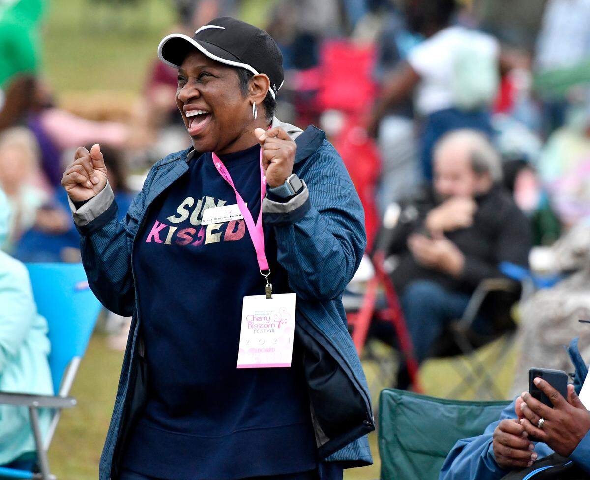 Karla Redding-Andrews dances while the Macon Pops perform during the Cherry Blossom Festival Tunes and Balloons finale Sunday night at Middle Georgia State.