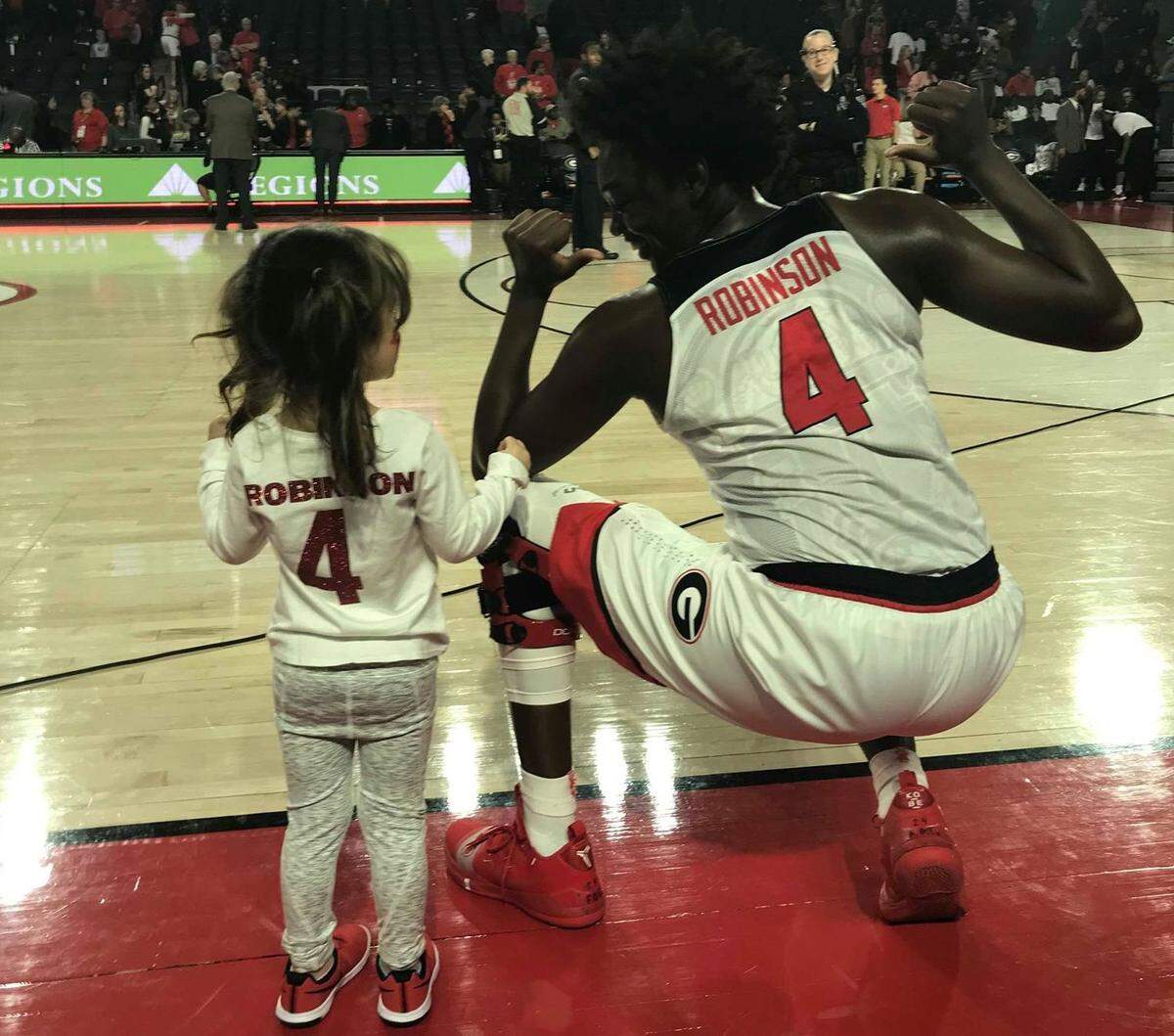 Aven Howell, left, poses with senior Caliya Robinson in their matching “jerseys.” Aven is such a big fan of Robinson that she asked her parents to make her a jersey she could wear to Georgia games.
