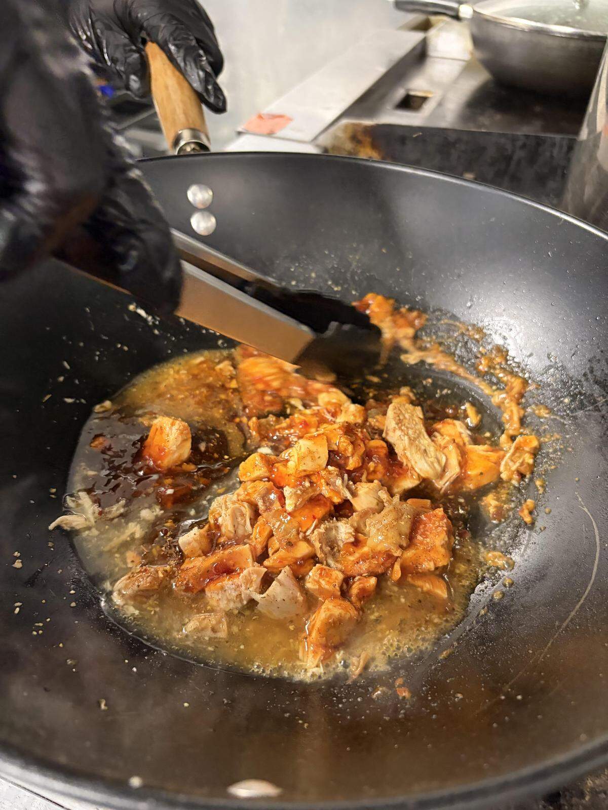 Soulful Eats owner Mika Jones sautés chicken breast meat for made-to-order sweet chili chicken tacos on a Taco Tuesday.