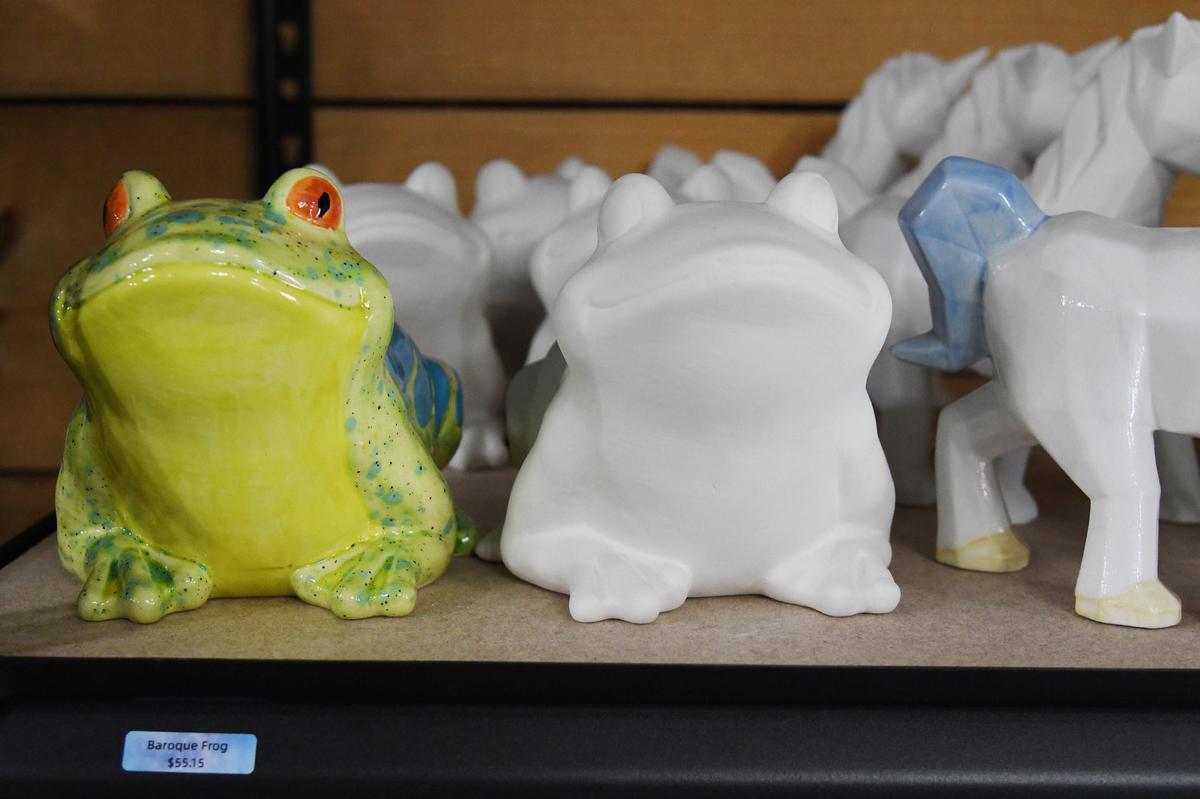 Painted and unpainted ceramic animals sit on a shelf in the Goodjuju Pottery Studio on Tuesday, July 9, 2024, in Forsyth, Georgia. Goodjuju Pottery Studio opened in March and offers pottery making and painting classes in downtown Forsyth.