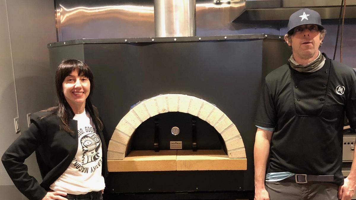Natasha and Carl Phillips pictured in front of a wood burning oven at her new restaurant, Romo’s Pizza, that’s expected to open the second week of February in the Prado shopping center on Forsyth Road in Macon. The new restaurant is located next to her Fountain of Juice eatery and in the former Barberitos Southwestern Grille & Cantina.