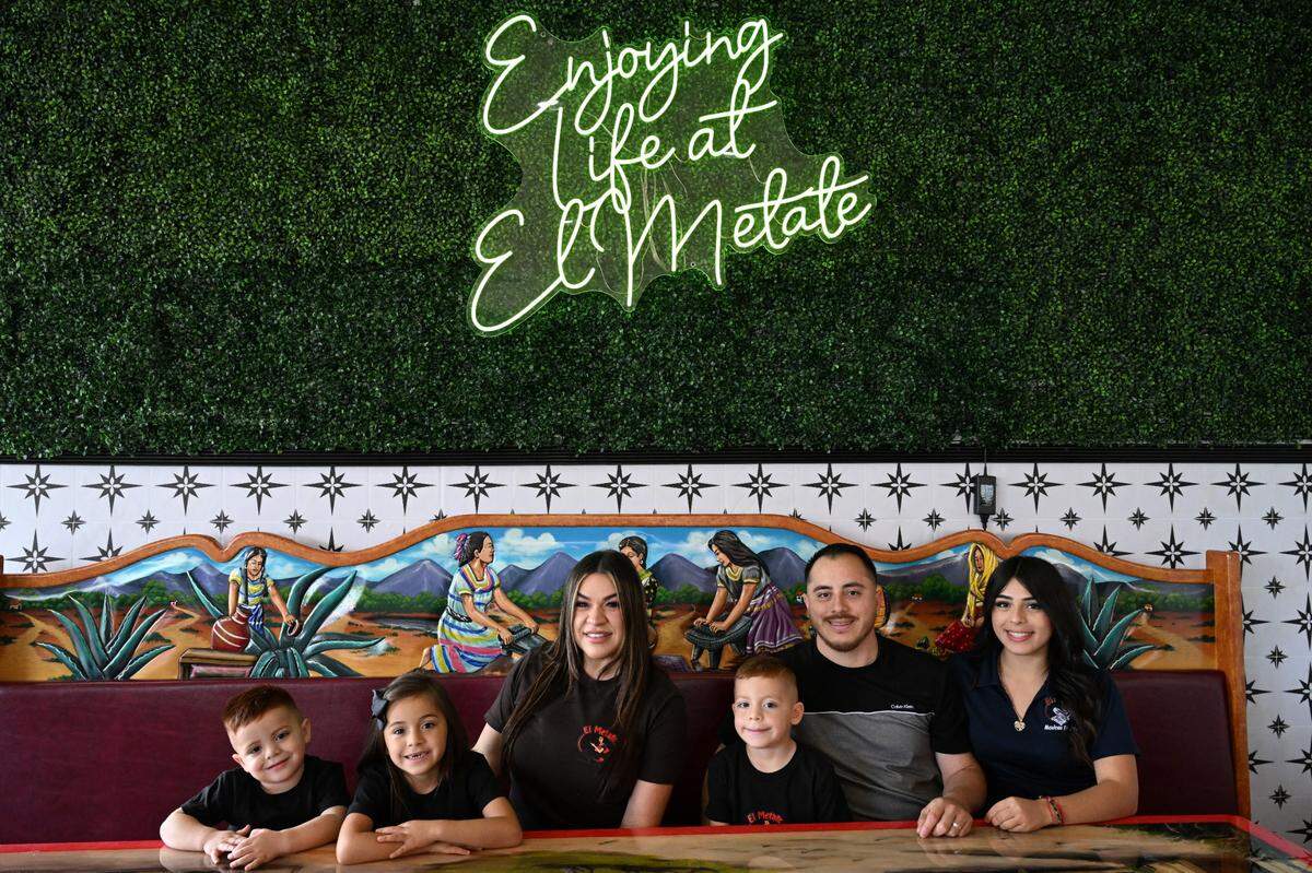 El Metate Mexican Restaurant owners Yuliana Barradas (left) and Fernando Barradas (right) pose with their four children in the new El Metate Warner Robins location on Wednesday, June 11, 2025, in Warner Robins, Georgia. The husband and wife duo expect their third El Metate location to open to the public in July. 