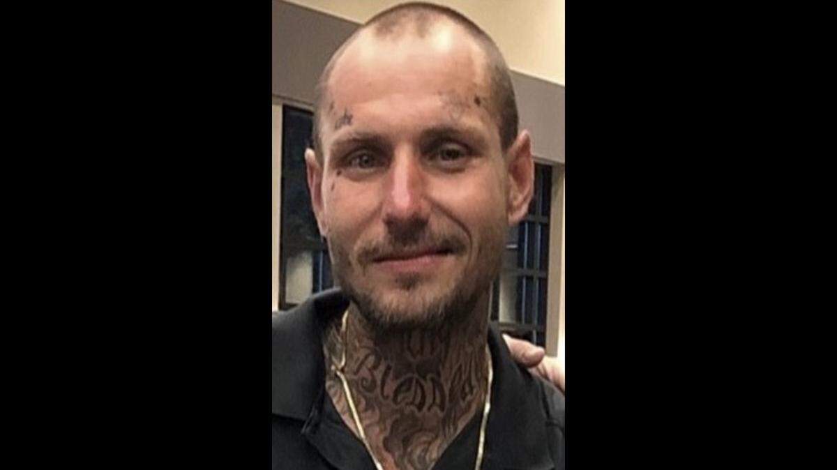 Dustin Wallce, 37, smiles with tattoos on his face and neck, with a gold chain and black shirt. Wallace was missing for over four years out of Perry, Georgia, by Thursday, Nov. 4, 2025, according to the Houston County Sheriff’s Office.