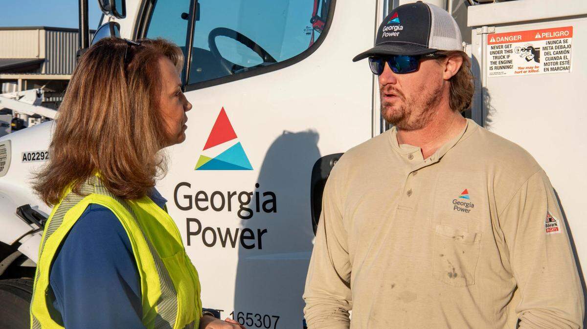 Georgia Power CEO Kim Greene speaks with a worker during Hurricane Helene recovery efforts.