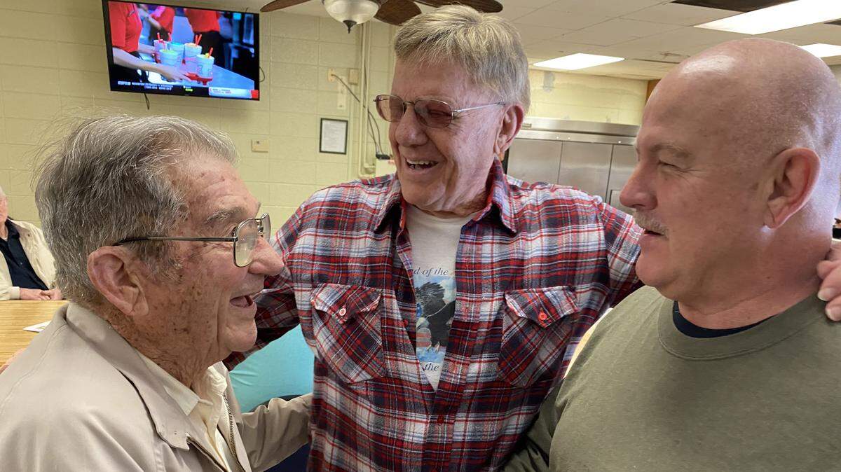 Ed Grisamore/For the Telegraph Fred Bell (left), who has taught Sunday School at Macon fire stations for 50 years, visits with Ken Smith (center) and Dickie Malone at firefighters reunion last Saturday to honor Bell for his service.