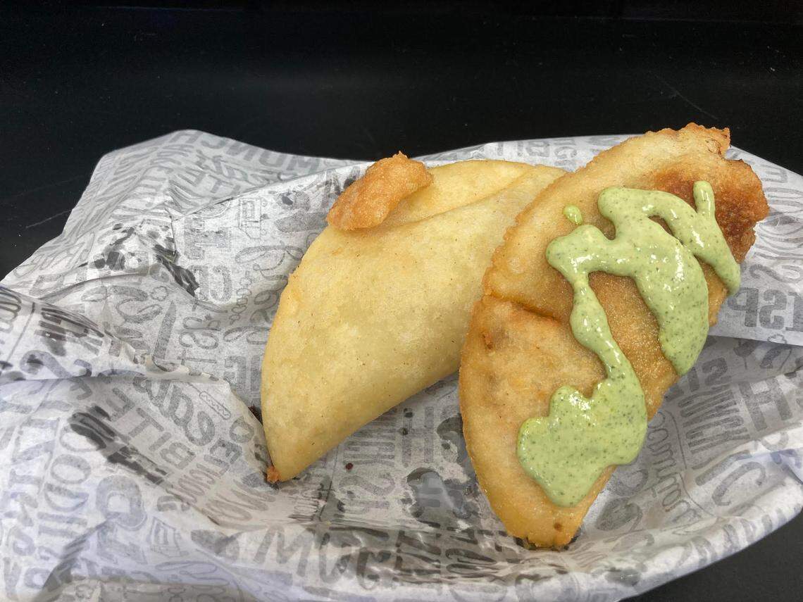 Empanadas at a new restaurant in Warner Robins that serves up Venezuelan cuisine. One is filled with shredded beef the other with ground beef. The shredded been empanada pictured here is drizzled in Salsa de Ajo, a garlic sauce with lime, parsley, chives and olive oil.