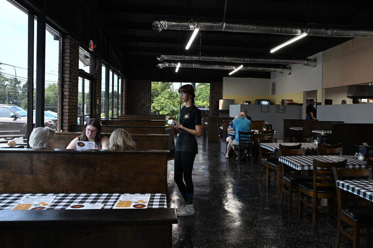 Waitress Lila Wortelboer takes customer orders at Home Slice Pizza on Tuesday, Aug. 26, 2025, in Perry, Georgia. The new restaurant located in downtown Perry opened in July and offers brick oven pizzas.