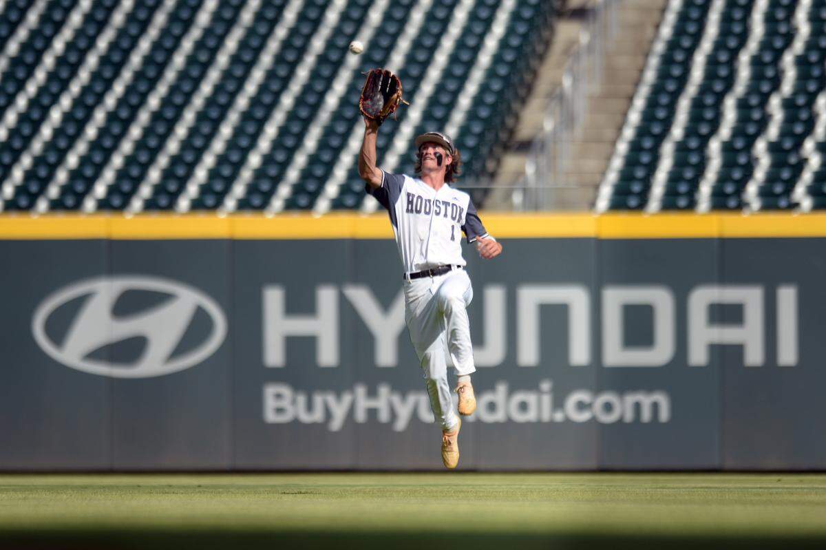 Houston County outfielder Gage Harrelson (1) leaps up to snag a fly ball during game one of the BearsÕ GHSA 6A Championship series against Lassiter Wednesday in Atlanta.